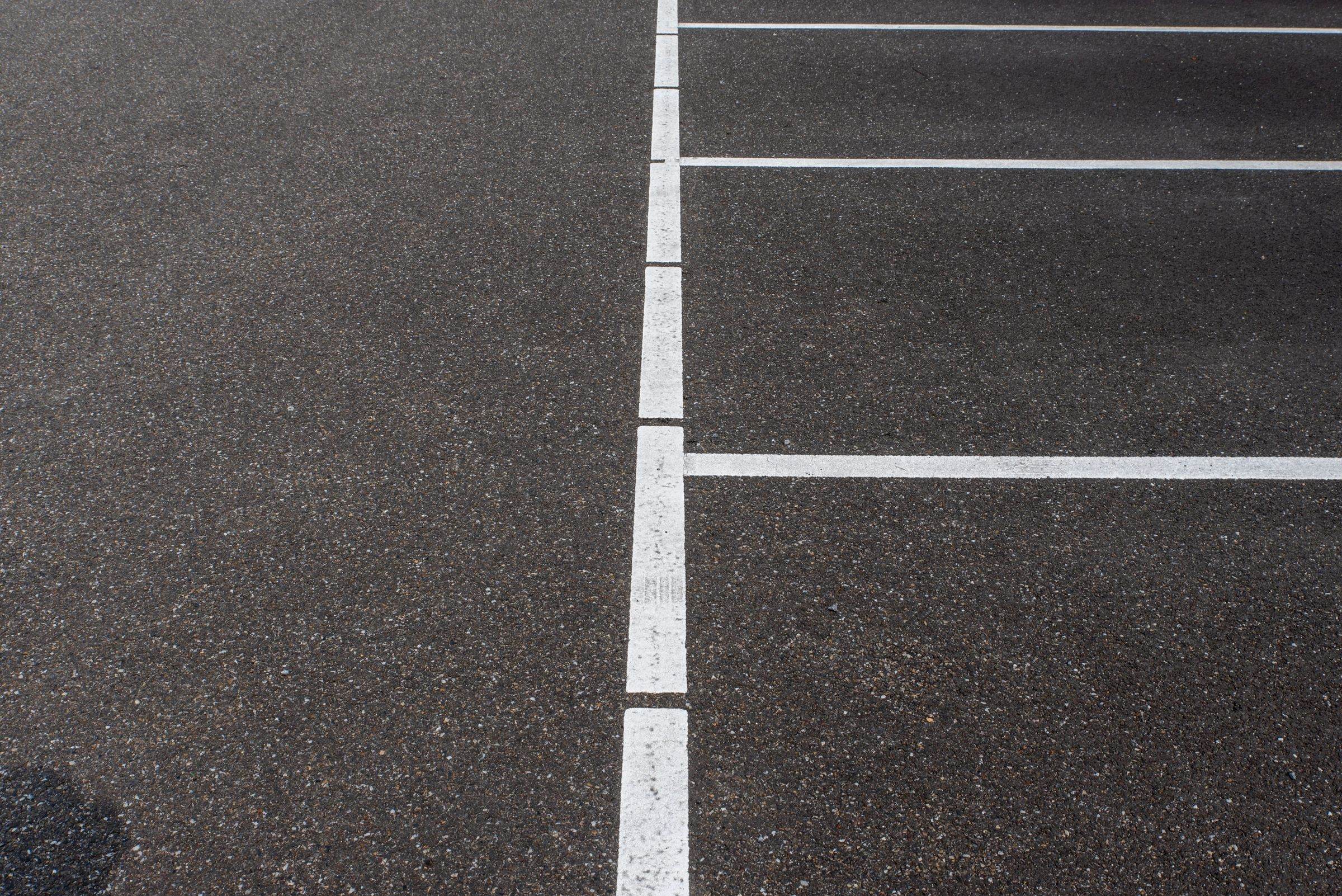 Freshly surfaced asphalt with crisp white bay markings