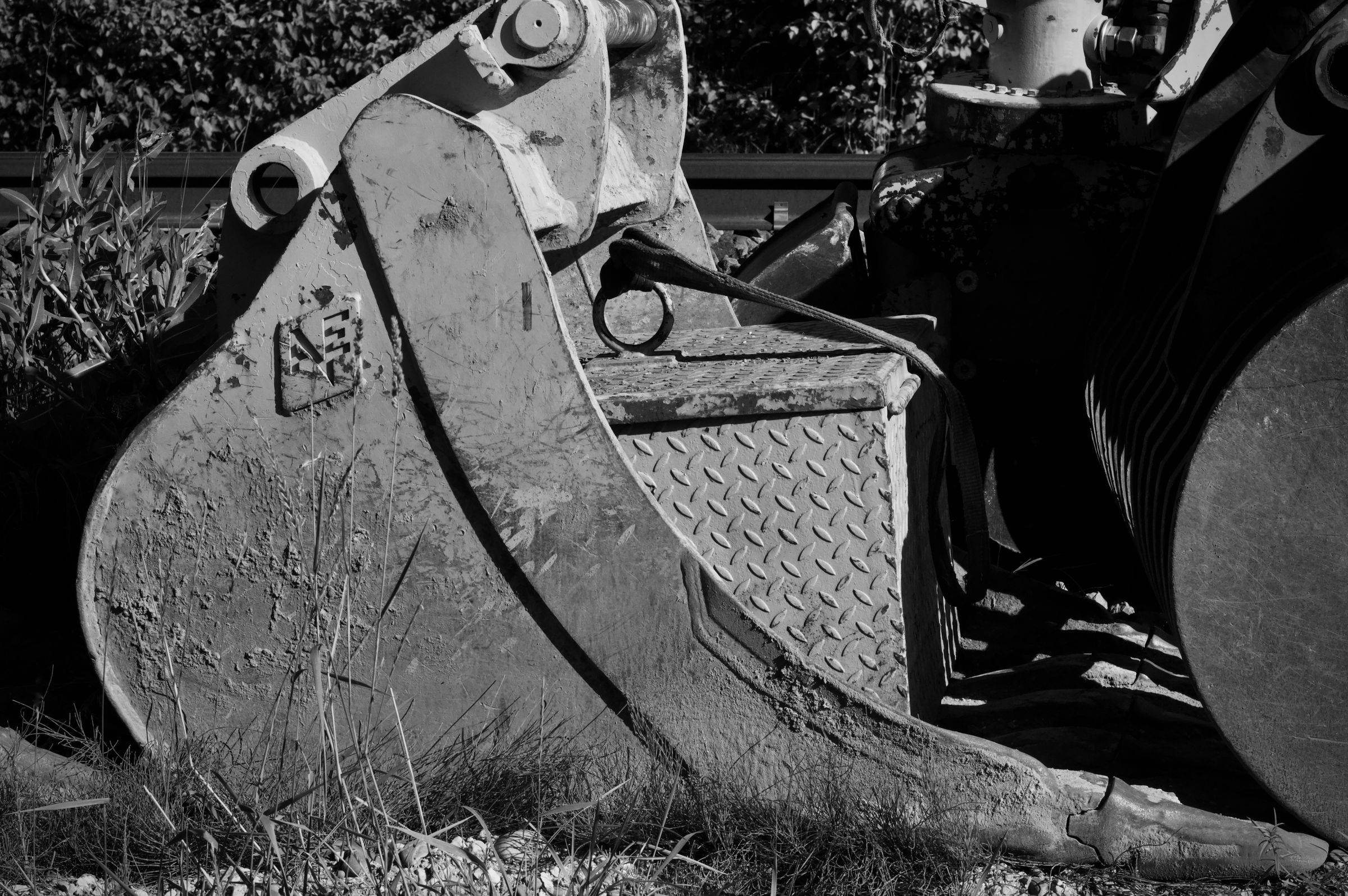 Close-up of an excavator bucket, in black and white